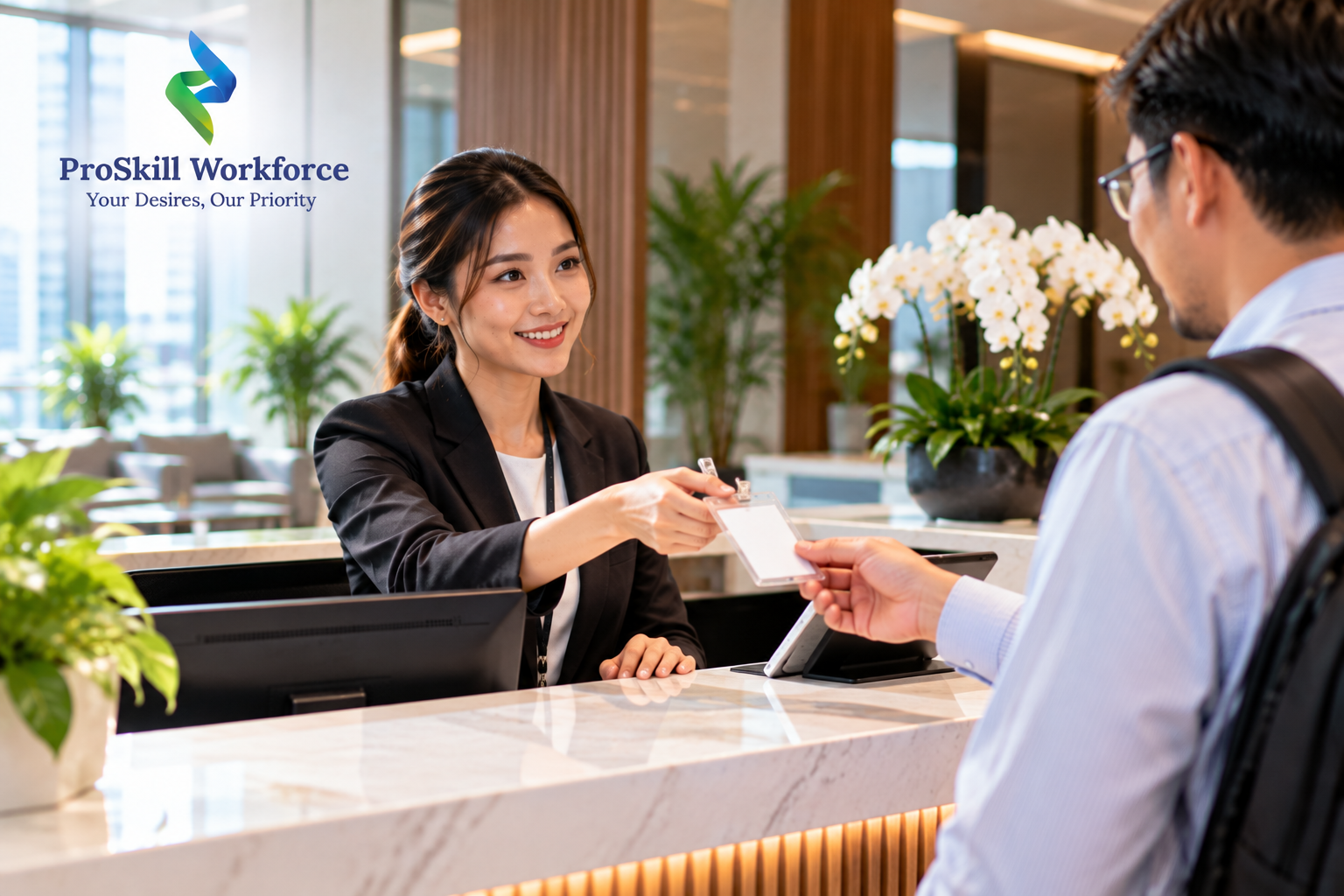 Receptionist handing a visitor pass at an office front desk